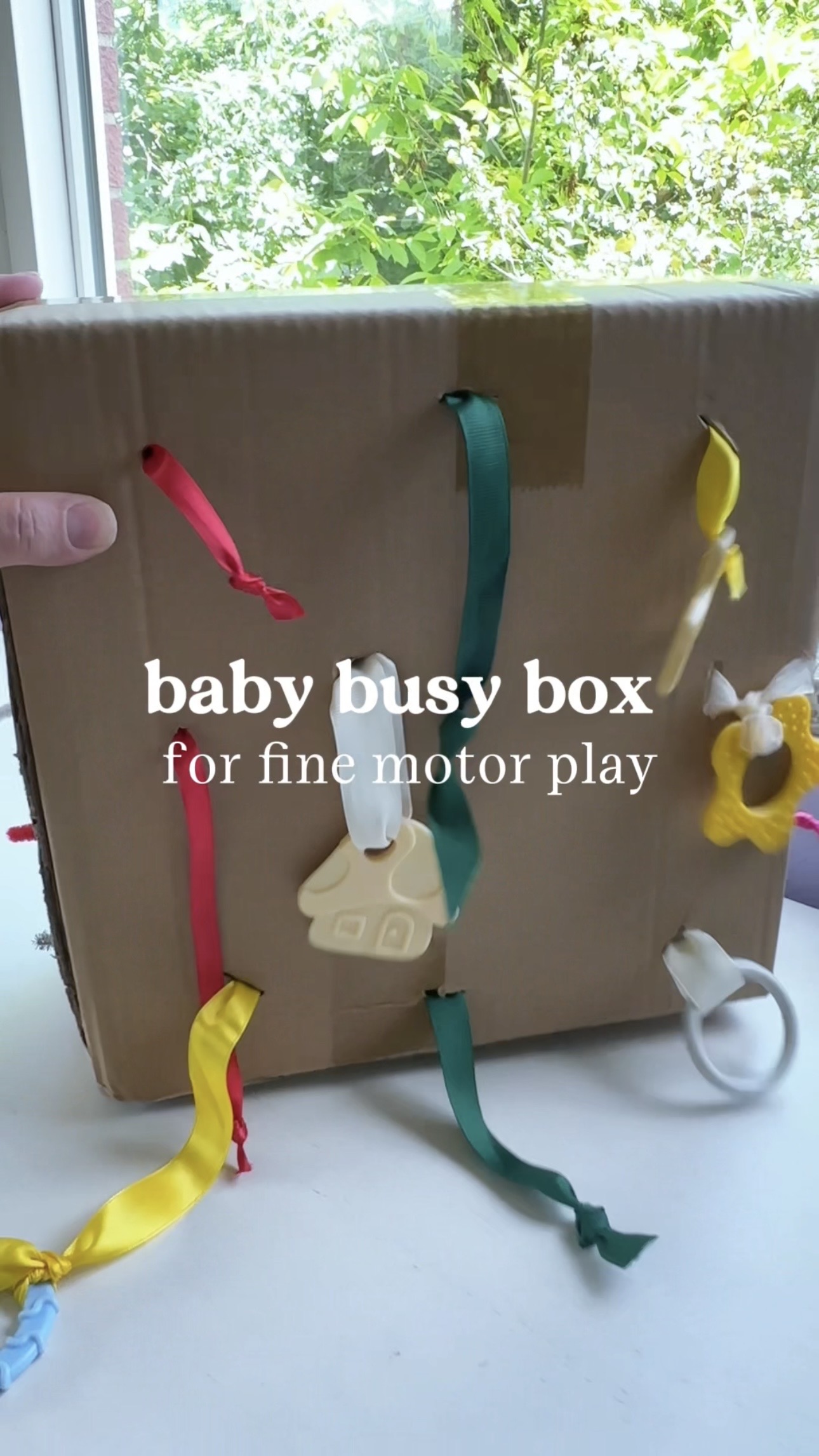Easy Ribbon Pull Activity for Babies Developing the Pincer Grasp
